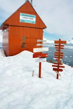 Signposts outside Brown Station along Paradise Harbor in the Antarctic. Stock Photos