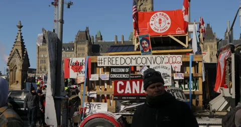 Signs of Protest in Ottawa at Freedom Protest with Crowds walking by Stock Footage 170331833