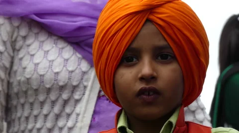 Sikh boy traditional orange headscarf Stock Footage 62892753