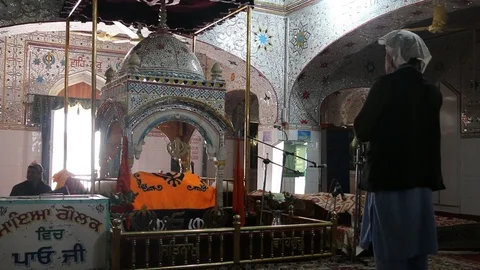A Sikh devotee praying inside Gurdwara Panja Sahib Video stock 86660028