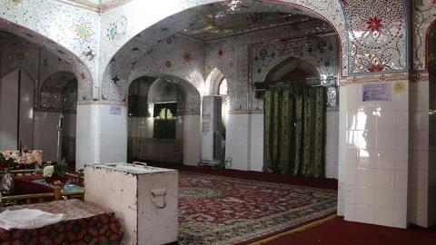 A Sikh devotee praying inside Gurdwara Panja Sahib Stock Footage 86660716