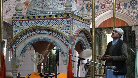 Sikh devotees fanning doing Chaur Sahib inside Gurdwara Panja Sahib Video stock 86659507