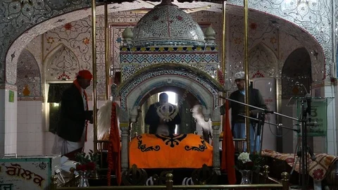 Sikh devotees fanning doing Chaur Sahib inside Gurdwara Panja Sahib Stock Footage 86659563
