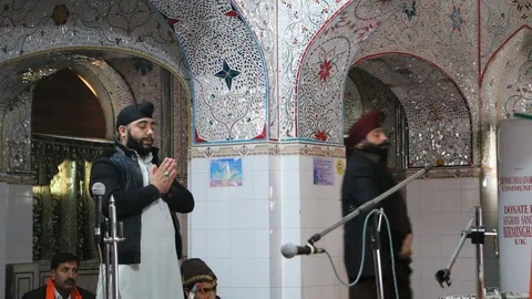 Sikh devotees praying inside Gurdwara Panja Sahib Stock Footage 86659252