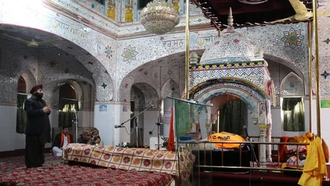 Sikh devotees praying inside Gurdwara Panja Sahib Stock Footage 86659357