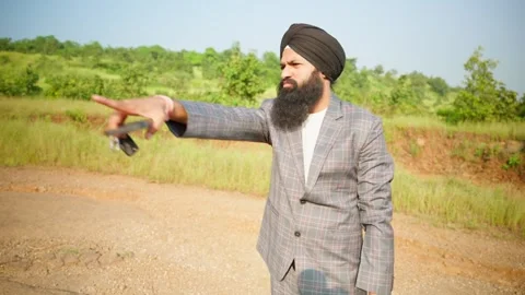 Sikh person stands at open plot surveying the property Vídeos de archivo 296533352