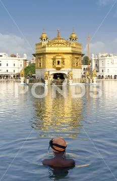 Sikh prayer in pond of Golden Temple in Amritsar, Punjab, India. Sikh Gurdwara Stock Photos