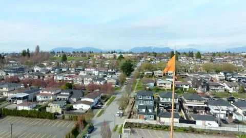 The Sikh Temple Flag Proudly Flutters, Set Against a Backdrop of Residential Stock Footage 294885780