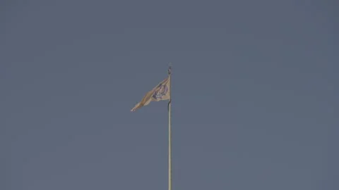 The Sikh Temple Flag Waves Proudly Against a clear blue sky Stock-Footage 316302140