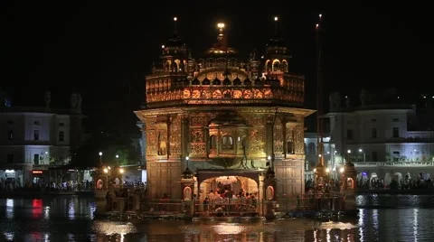 Sikhs and indian people visiting the Golden Temple in Amritsar at night. India Stock Footage
