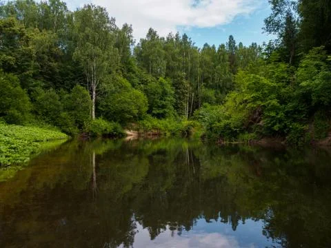 Silence on the river in the middle of the forest. Unique natural locations fa Stock Photos