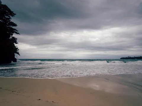 Silent beach scene with soft sand leading to gentle waves 스톡 사진