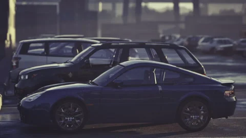 Silent city lot features sleek coupe under fading evening light Stock-Footage 335595679