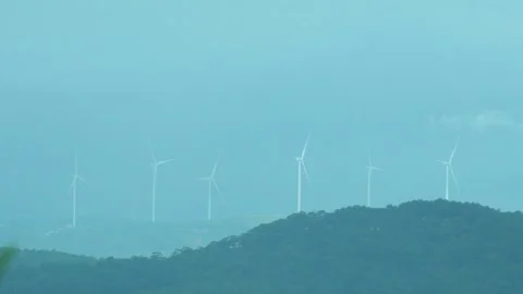 Silent Giants: Wind Turbines Over Rolling Hills Stock Footage 285698221