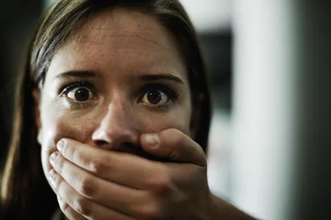 Silent pleas for help. A terrified young woman held captive by a man with his 写真素材
