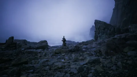 Silent ritual scene. Serene stack of rocks under gentle bluish fog cover Stock Footage 340344945