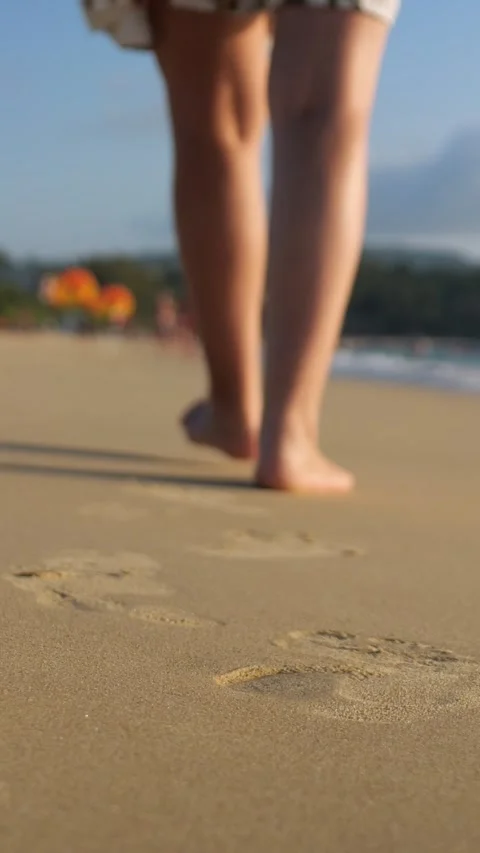 Silent Steps Across Sunlit Coastal Sands. Serene Journey Along Warm Beach With Stock Footage 334614708