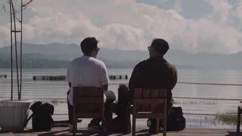 A Silhouette of 2 Men are having conversations on the chair Stock Footage 337245940