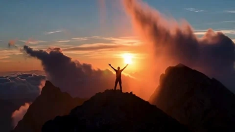 Silhouette of Adventurous Man Reaching Mountain Top at Sunset with Orange S.. Stock Footage 321948151