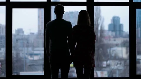 Silhouette of affectionate couple embracing Video stock 75069981