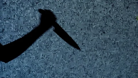 Silhouette against digital television screen. Thriller scene woman hand holding Stock Footage 265560877