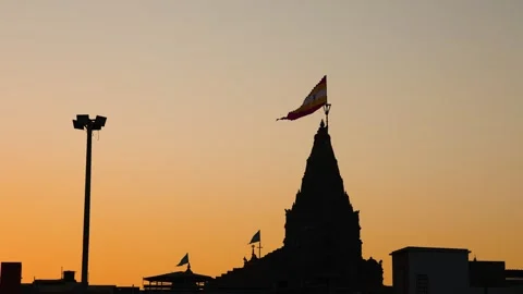 Silhouette of ancient hindu dwarkadhish temple shikhara with holy flag at s.. Video stock 322802268
