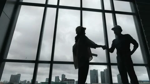 Silhouette of Architect and Engineer shaking hands while working for teamwork Видео 150473610