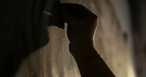 Silhouette of artist using charcoal on mural 180 FPS Stock Footage