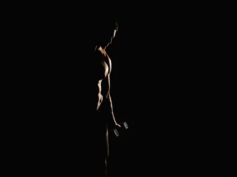 Silhouette of athletic man working out with dumbbells black background Stock Footage 75151162