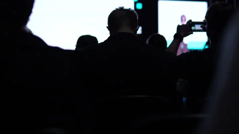 Silhouette Of Audience Members Recording Tech Conference Presentation On Stock Footage 338010215