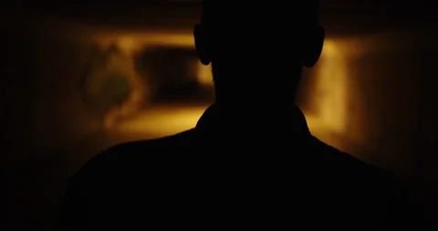 Silhouette of the back of a man walking in a dark underpass. Dark scary movie Stock-Footage 170441164