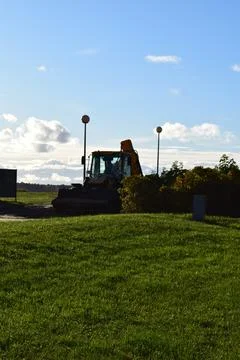 Silhouette of a Backhoe Loader on a Construction Site at Sunset Stock-Fotos