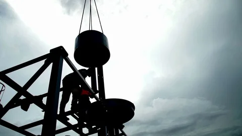 Silhouette backlight of some workers on a high fence. About construction sites Stock Footage 71085764