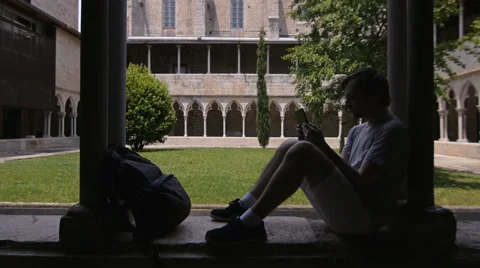 Silhouette backpacker using digital tablet computer. Student in girona Video stock 64276014