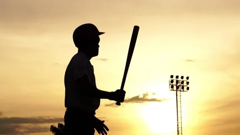 Silhouette baseball player holding a baseball bat to hit the ball drills Stock Footage 112139730