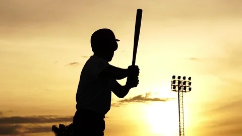 Silhouette baseball player holding a baseball bat to hit the ball drills Stock Footage