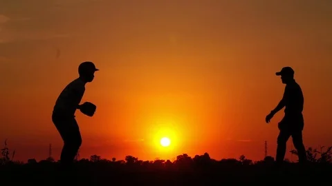 Silhouette baseball, two men were practicing throwing a baseball  Video stock 112949957