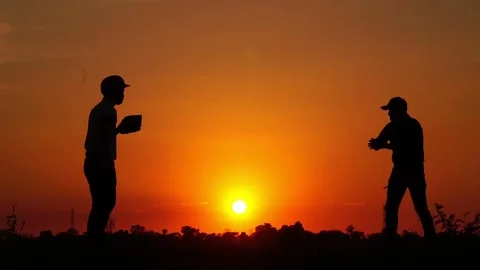 Silhouette baseball, two men were practicing throwing a baseball  Stock Footage 112949967
