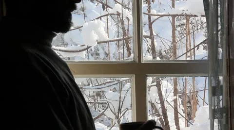 The silhouette of a bearded man standing at the window in a village house Stock Footage 60798261