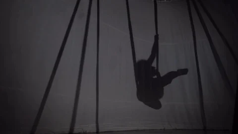 Silhouette of a beautiful girl engaged in yoga air Stock Footage