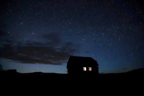 Silhouette of a beautiful village house against the background of the starry sky Stock Photos
