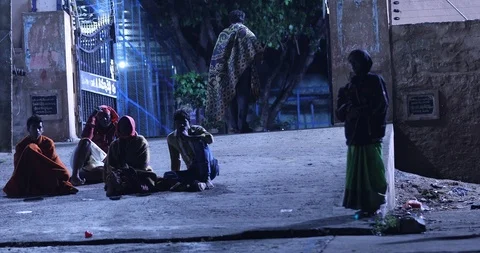 Silhouette of Beggars on footpath Stock Footage 113505200