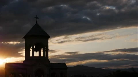 Silhouette of bell tower in the rays of sunset. Time-lapse Stock Footage 163447186