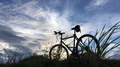 Silhouette bicycle parking and cloudscape. Stock Footage 76650723
