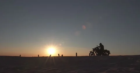 Silhouette of a biker during sunset Video stock 157102365