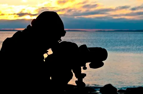 Silhouette of a birdwatcher Stock Photos