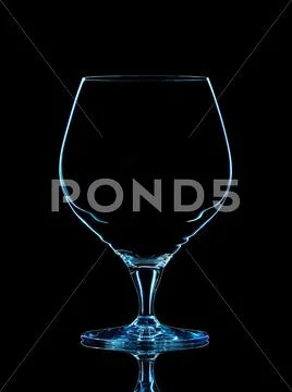 Silhouette of blue whiskey glass with on black Stock Photos
