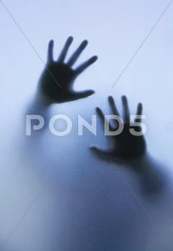 Silhouette of body through frosted glass for HELP. Stock Photos