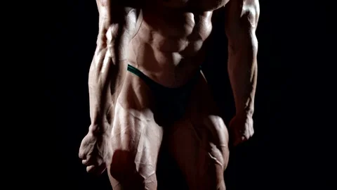 The silhouette of a bodybuilder in a dramatic light highlights   Stock Footage 297610127