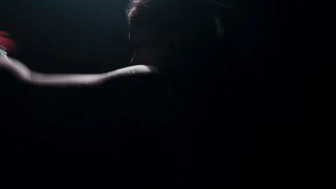 Silhouette of a boxer practicing a quick strike shadow boxing fight Stock Footage 274450186